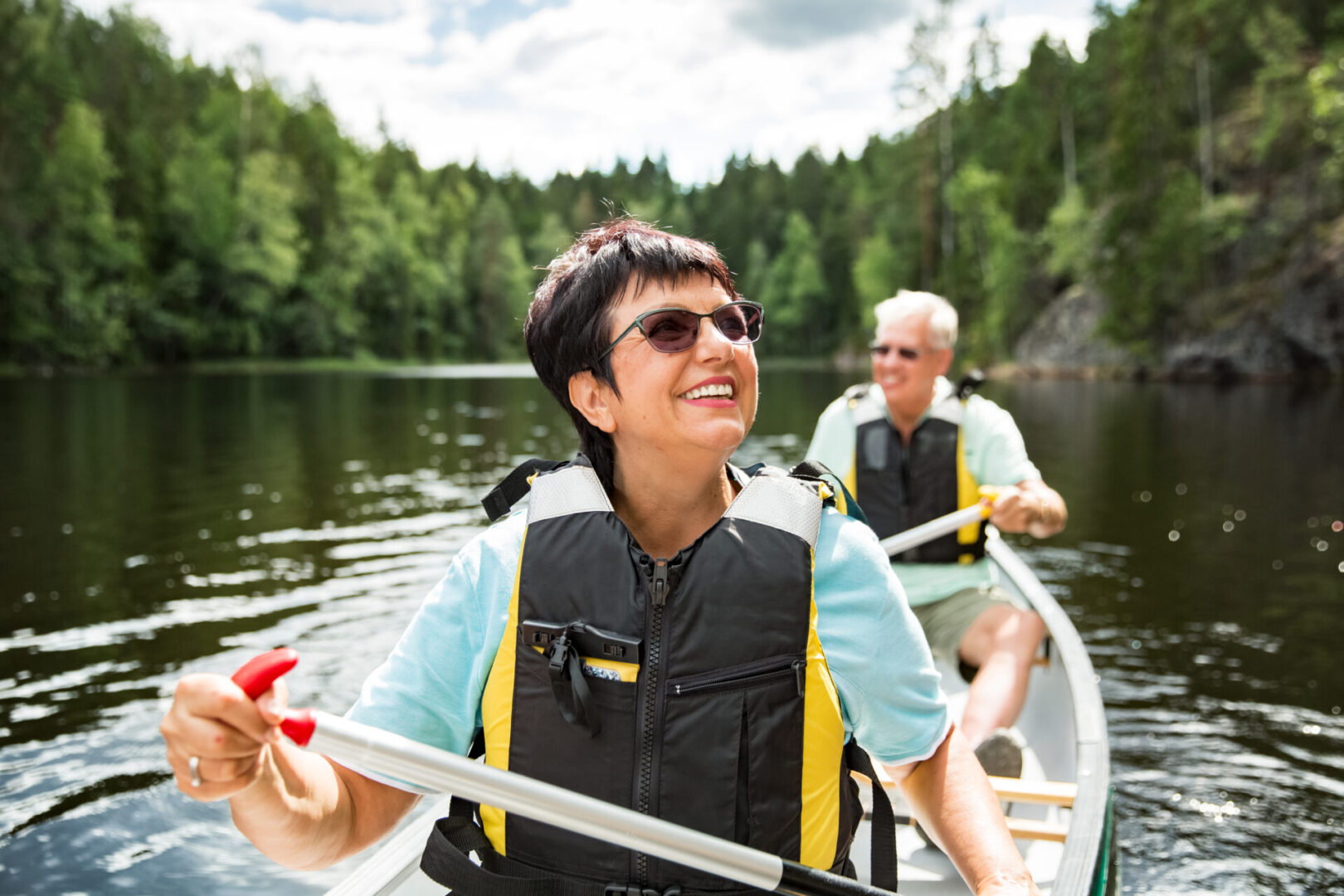 Happy,Mature,Couple,In,Life,Vests,Canoeing,In,Forest,Lake.