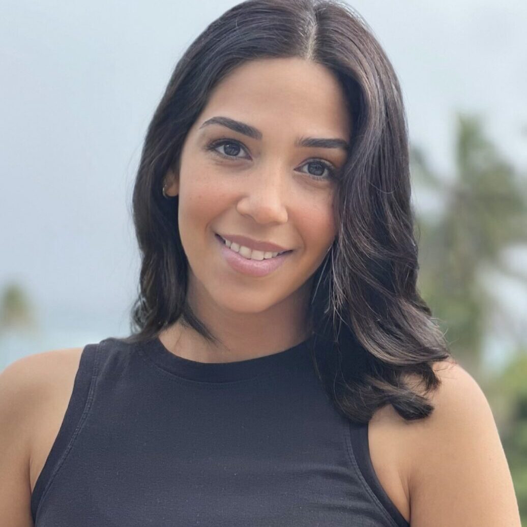 A woman in black shirt smiling for the camera.